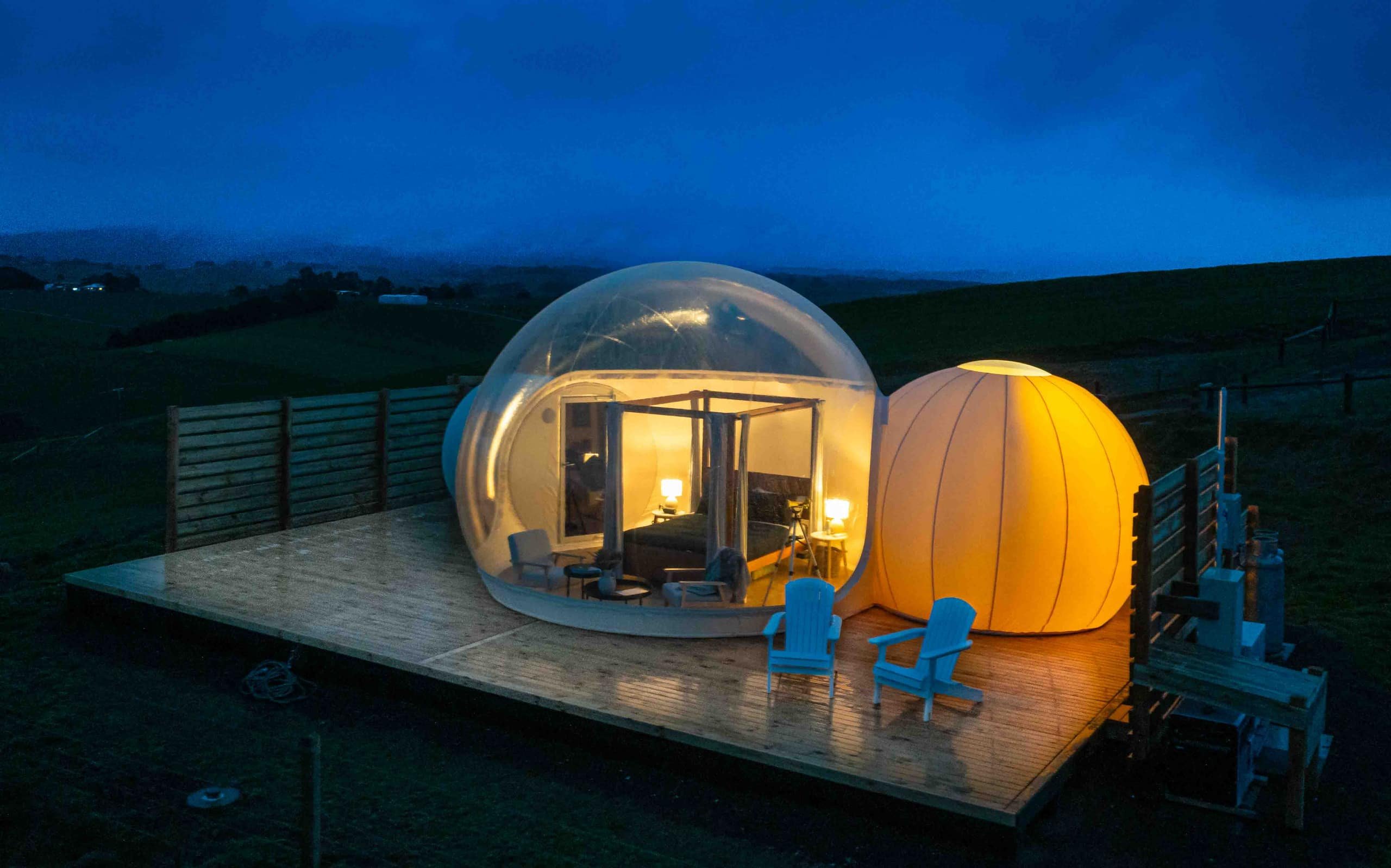 Aerial view of both bubbles glowing on the deck at twilight